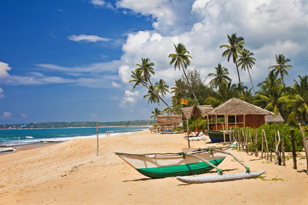 deserted tropical beach with boat, sri lanka